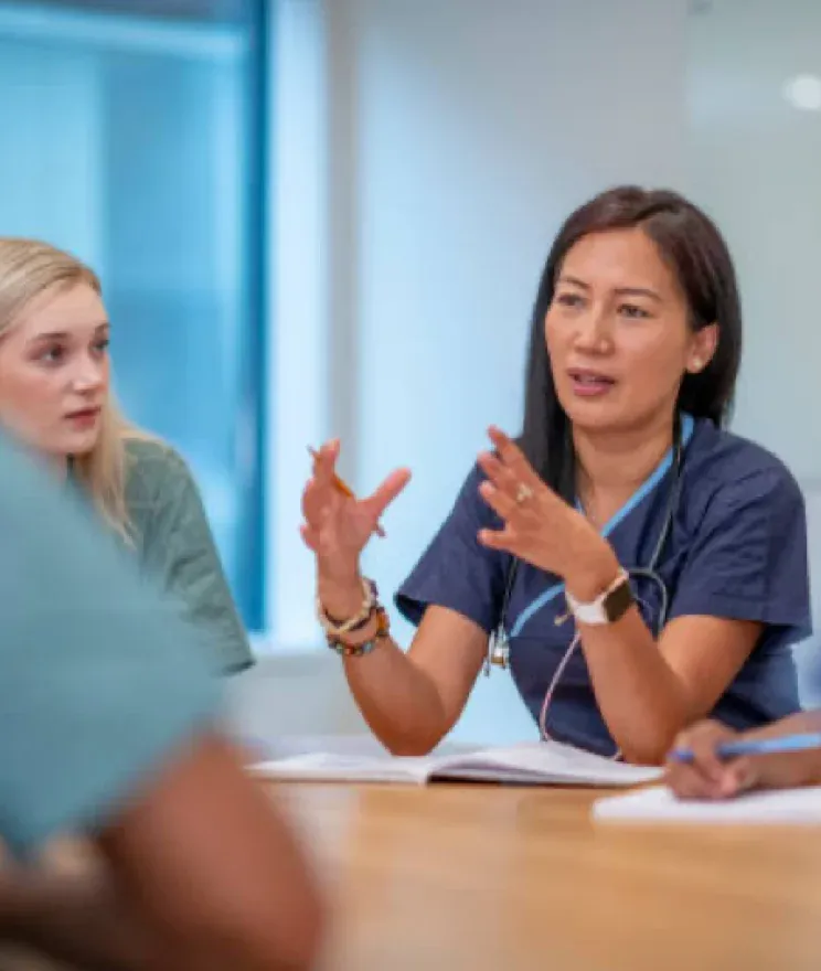 women at table sharing information