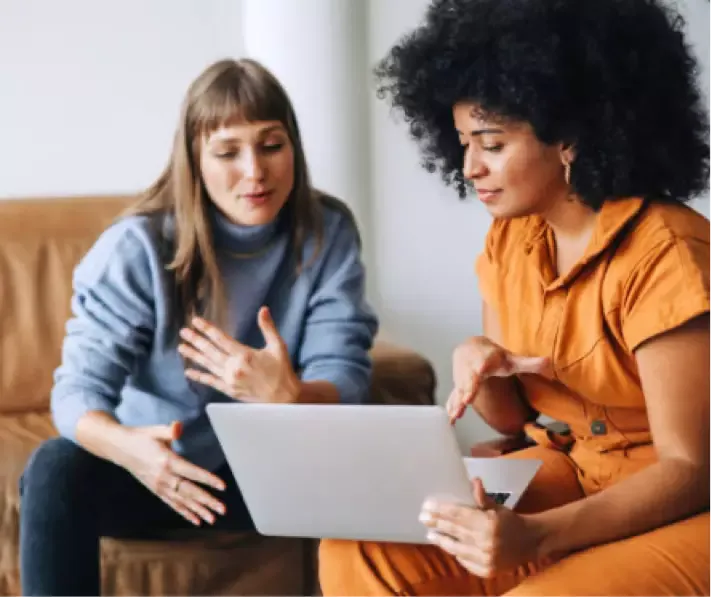 two women looking at laptop