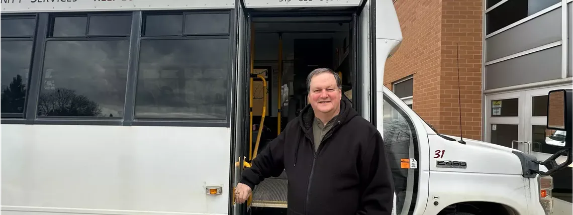 man outside of vehicle smiling